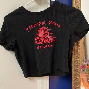blacktake out box crop top with red lettering